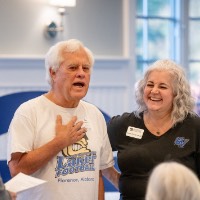 Susan Proctor laughing with Jim Spaanstra